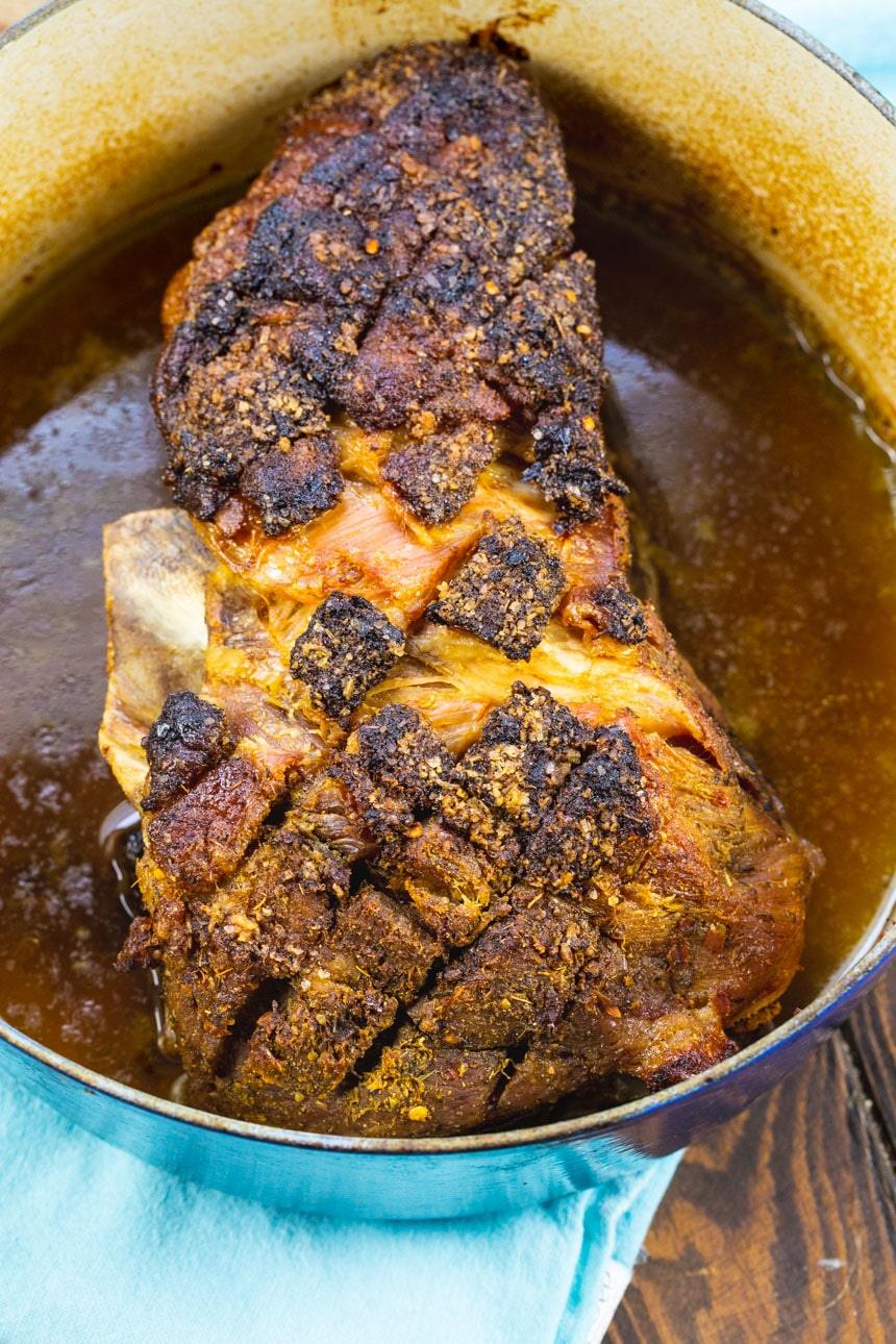 Whole cooked pork butt in Dutch oven.