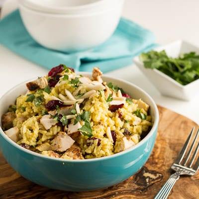 Curried Rice Salad with in a blue bowl.