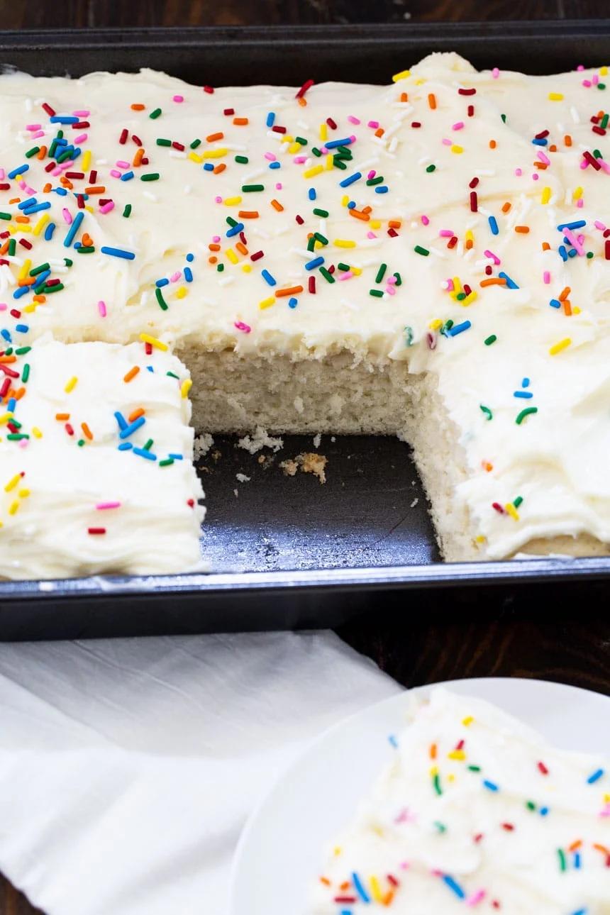 Sheet cake in baking dish with 1 slice cut out.