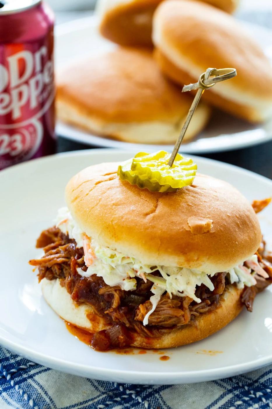 Slow Cooker Dr. Pepper Pulled Pork on a bun with coleslaw.
