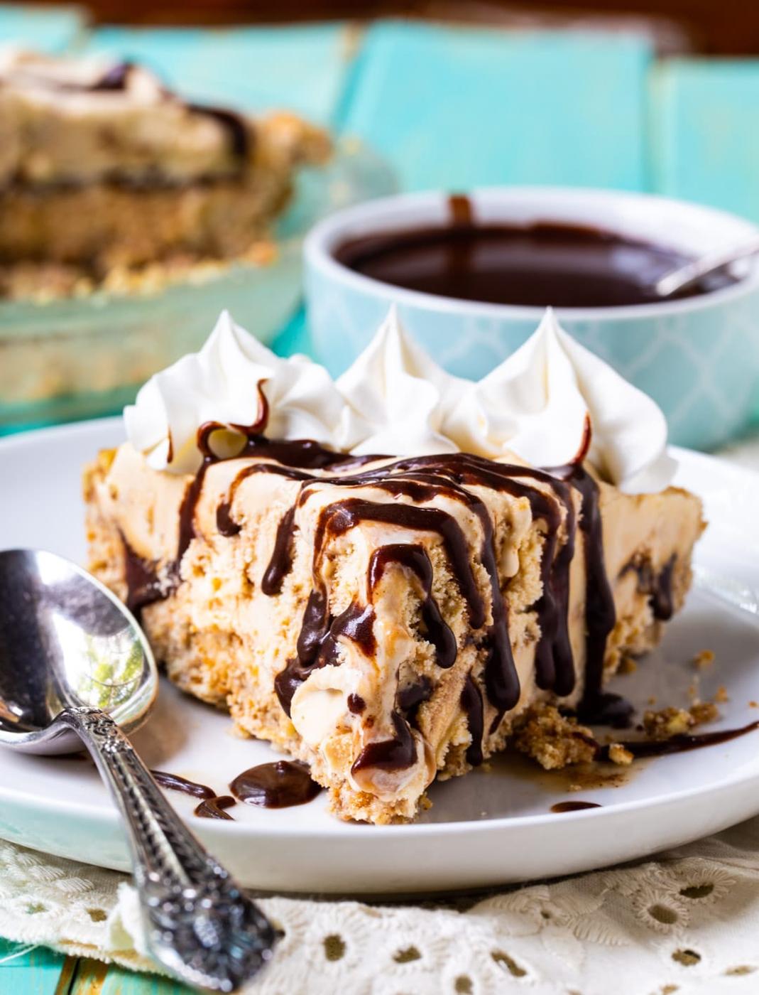 Slice of ice cream pie drizzled with fudge sauce.