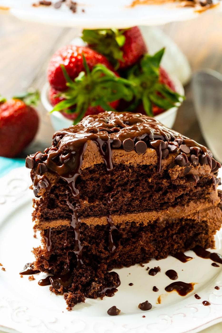 Slice of chocolate cake with fresh strawberries.