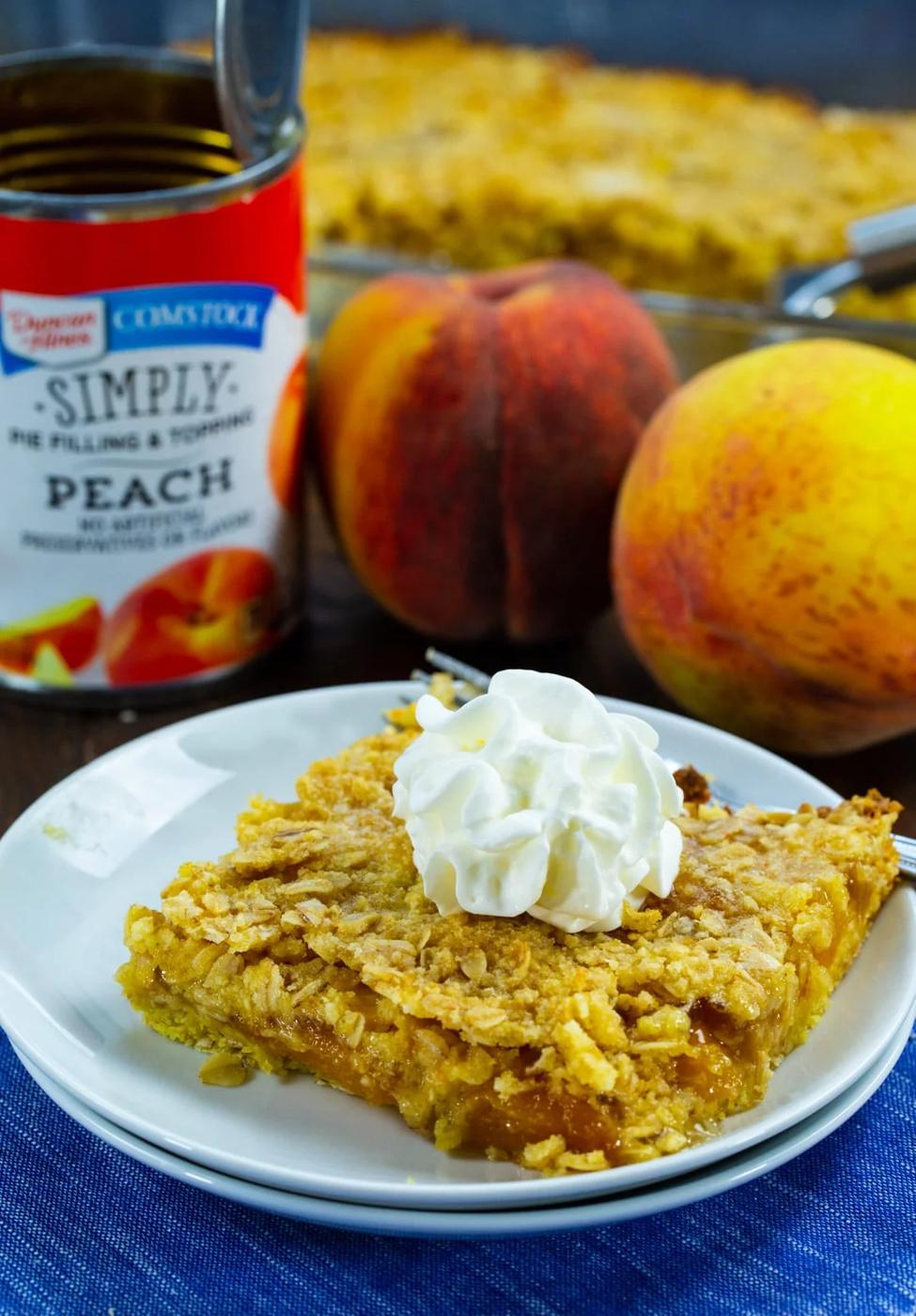 Easy Peach Bar topped with whipped cream.