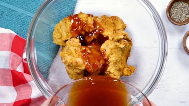 Pouring the sauce over chicken.