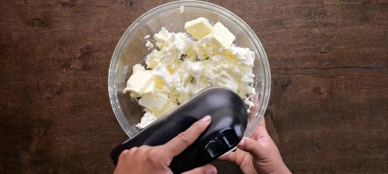 Creaming butter and cream cheese.