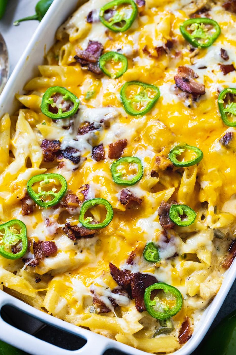 Chicken Casserole topped with jalapenos in baking dish.