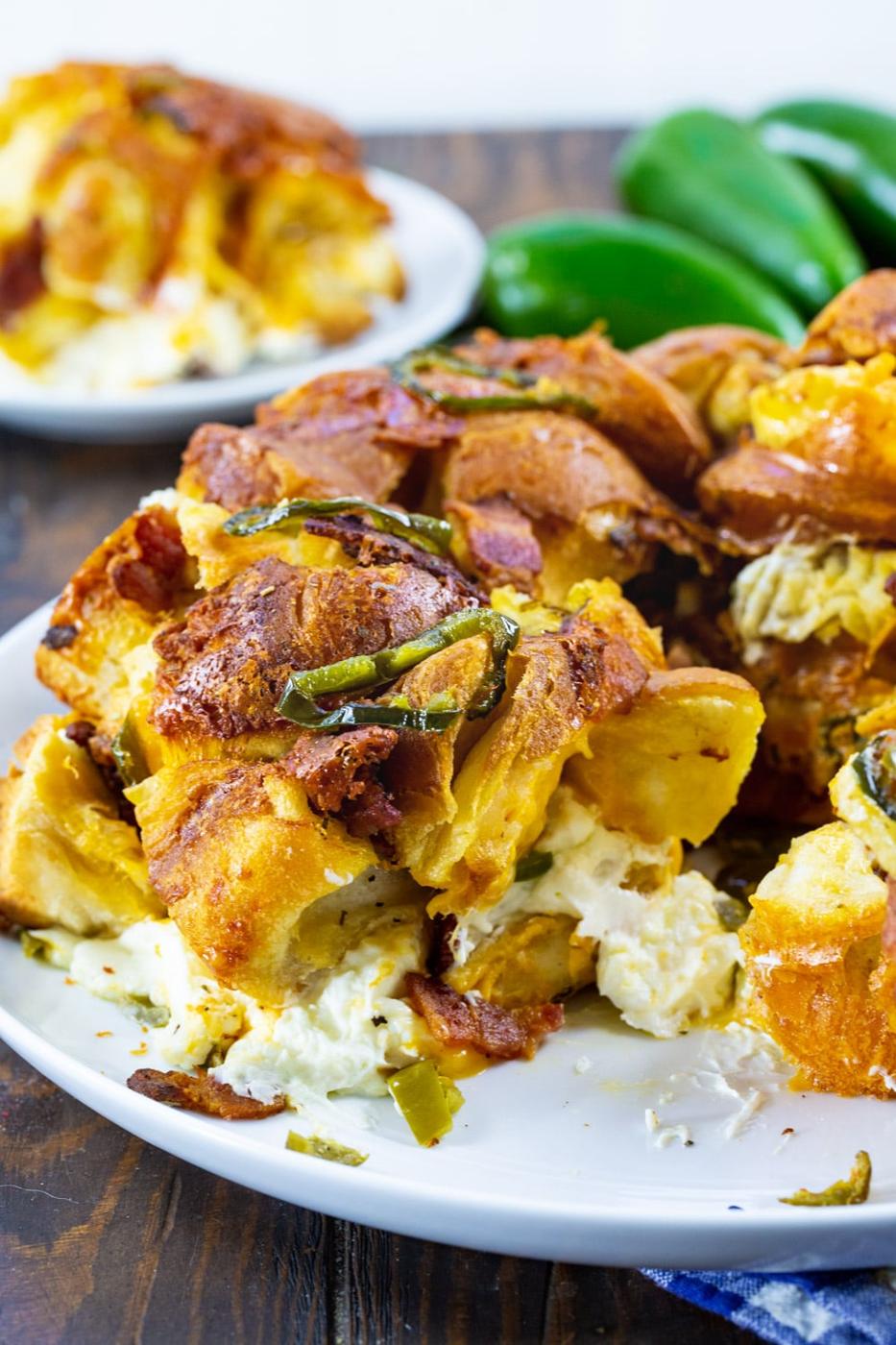 Jalapeno Popper Monkey Bread with piece removed to show the cream cheese in the middle.