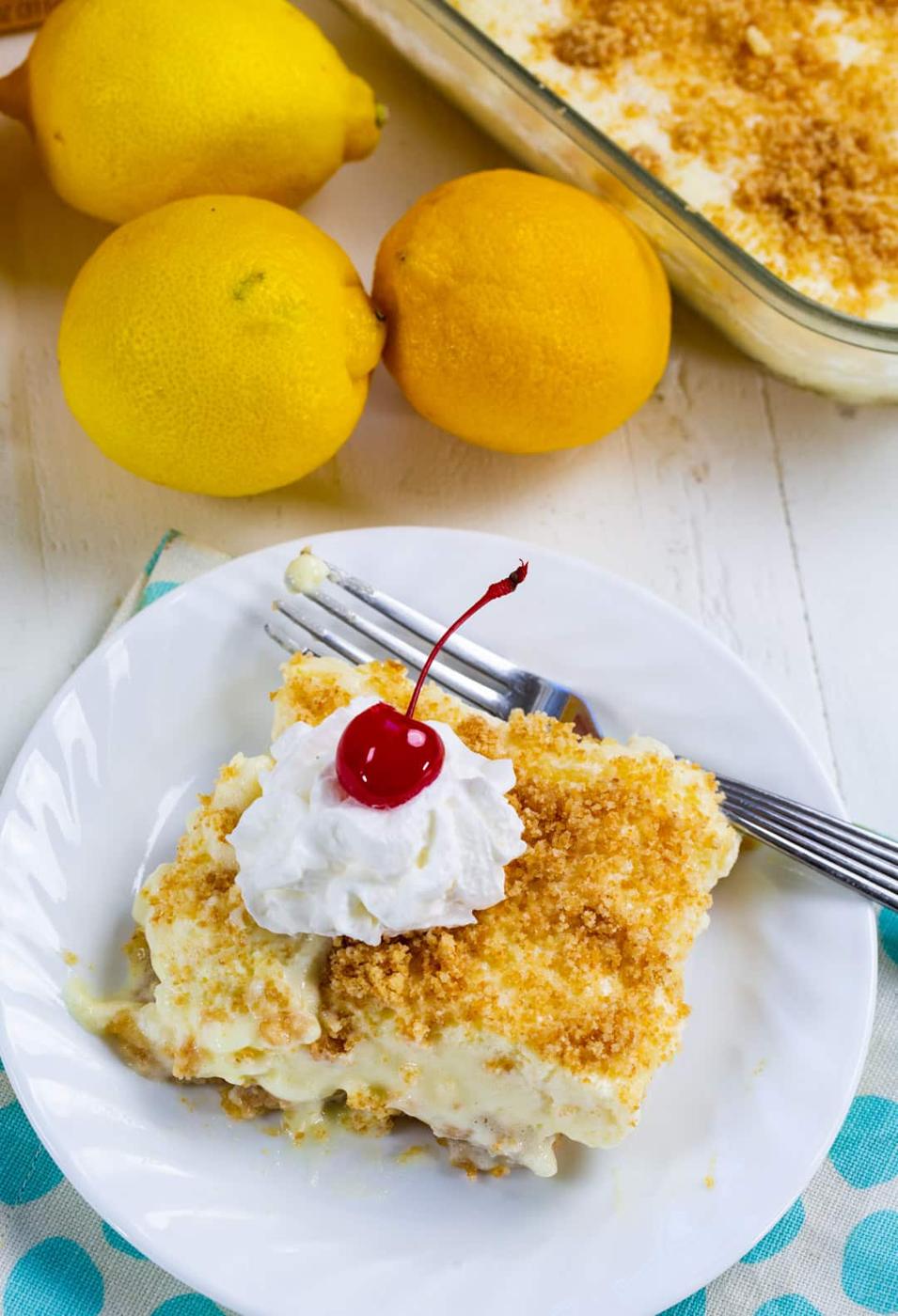 Slice of fluff topped with whipped cream and a cherry.