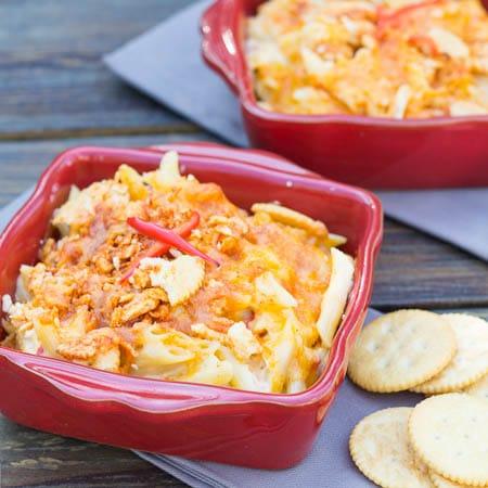 Two small red casserole dishes full of Pimento Mac and Cheese.