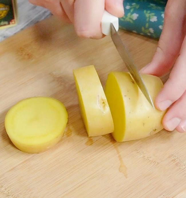 Cutting potato slices.
