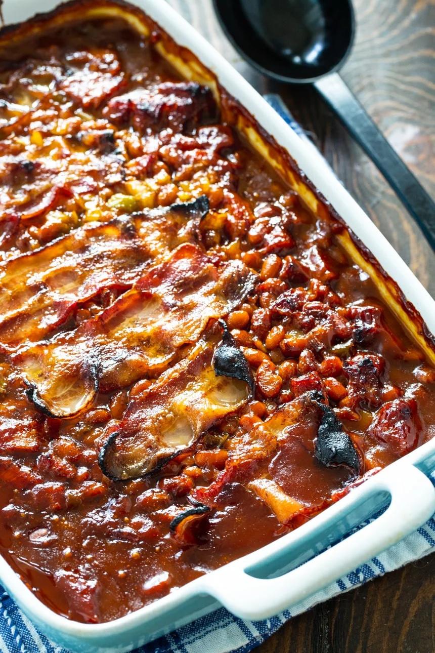 Molasses Baked Beans with Strips of bacon in a baking dish