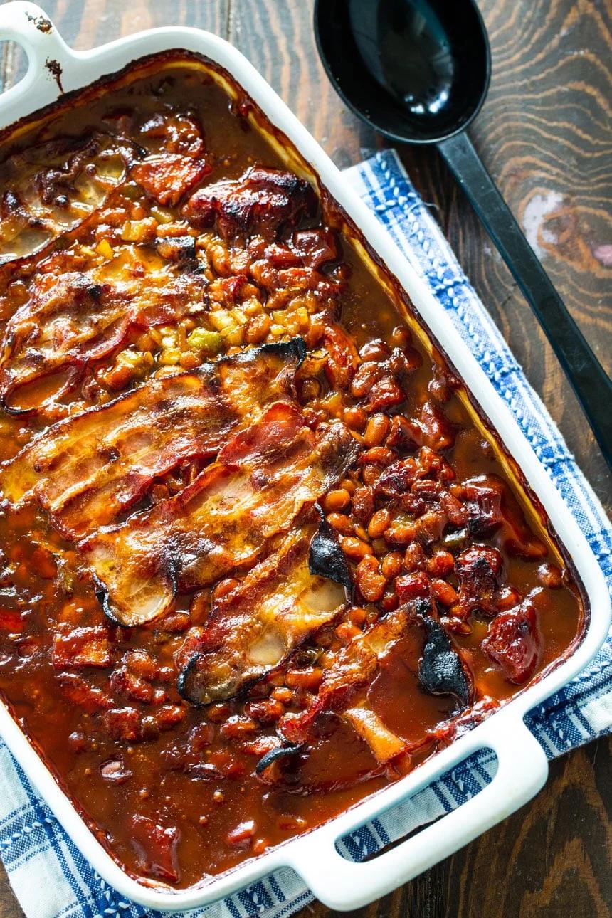 Molasses Baked Beans in a baking dish with serving spoon
