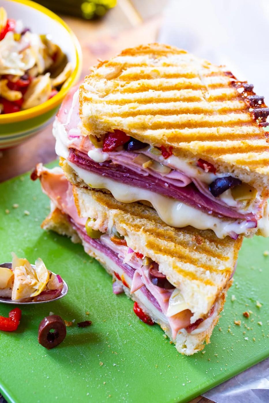 Muffaletta Panini cut in half and stacked.