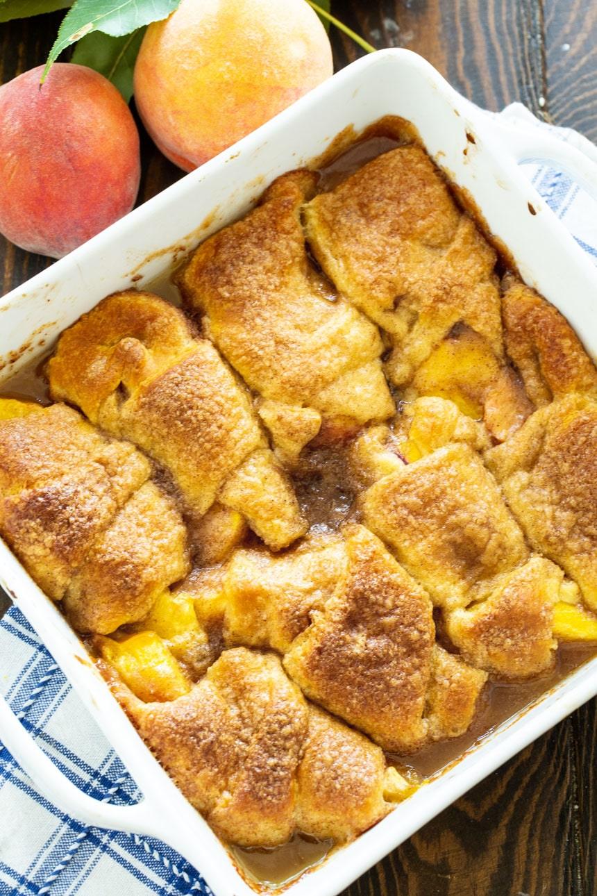 Baking dish full of peach dumplings