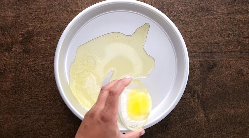 Melted butter poured into cake pan.