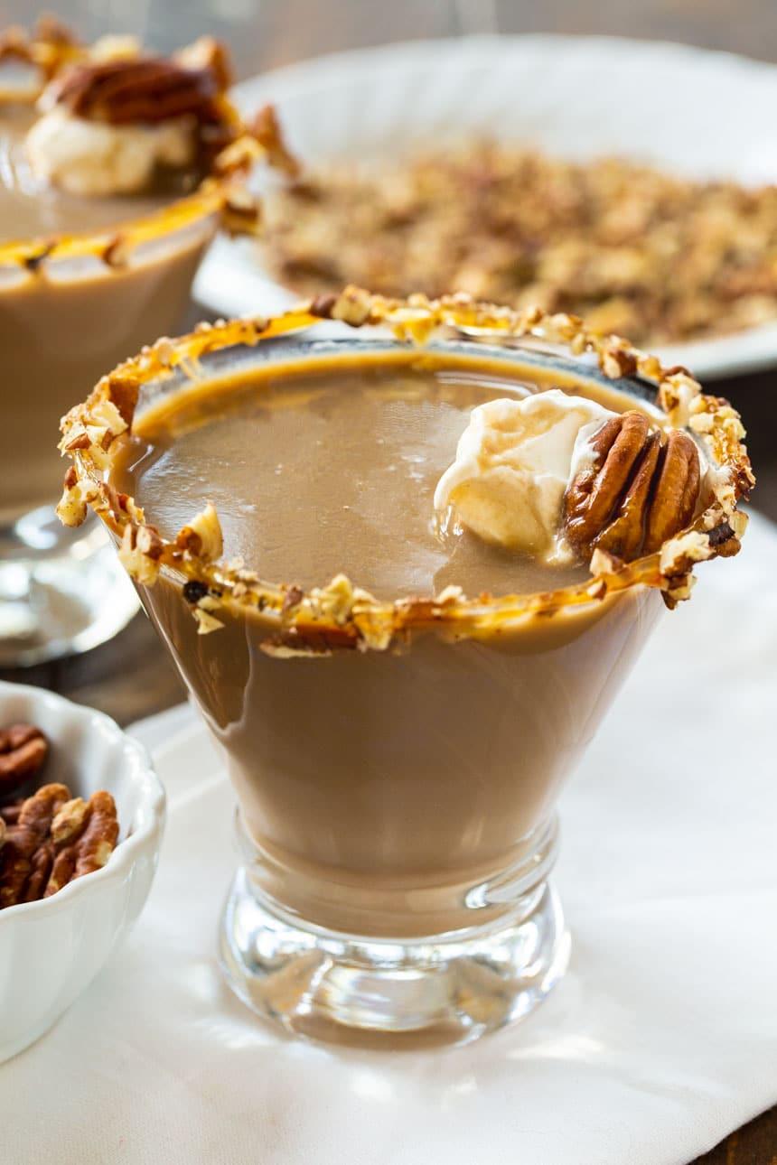 Pecan Pie Martini with plate of chopped pecans in background.