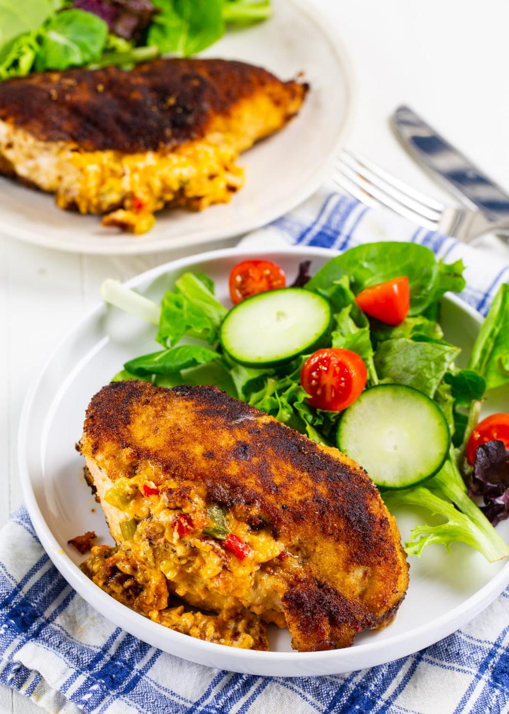 Cooked Stuffed Chicken Breast on plate with salad.