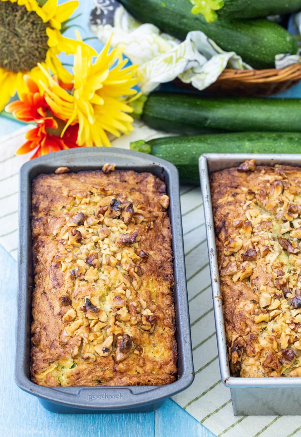 Two Loaves of zucchini bread in baking pans.