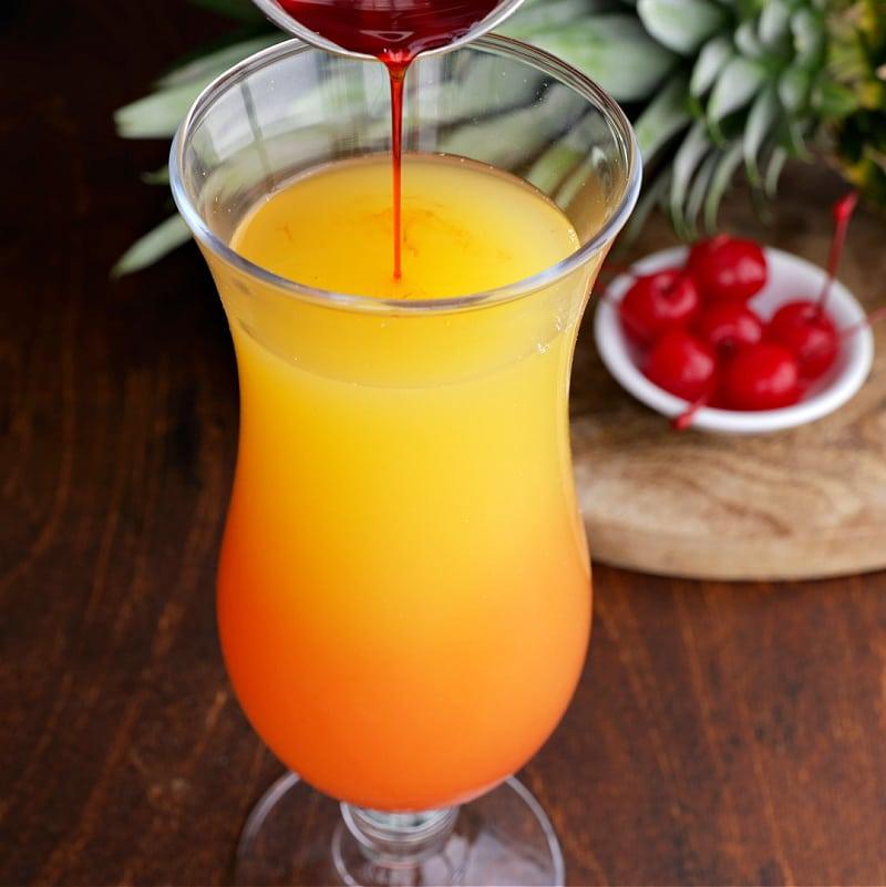 Grenadine being poured into glass.
