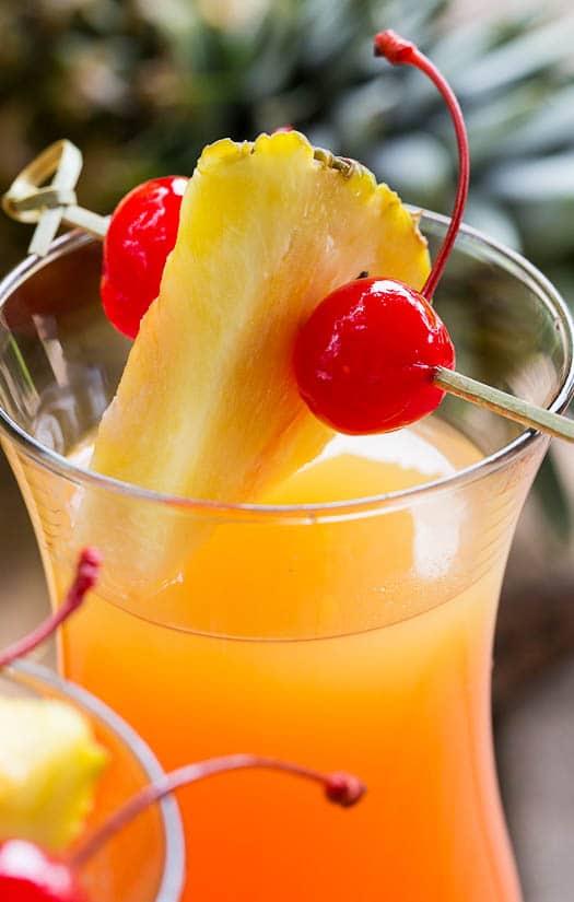 Pineapple Upside Down Cocktail in a hurricane glass.