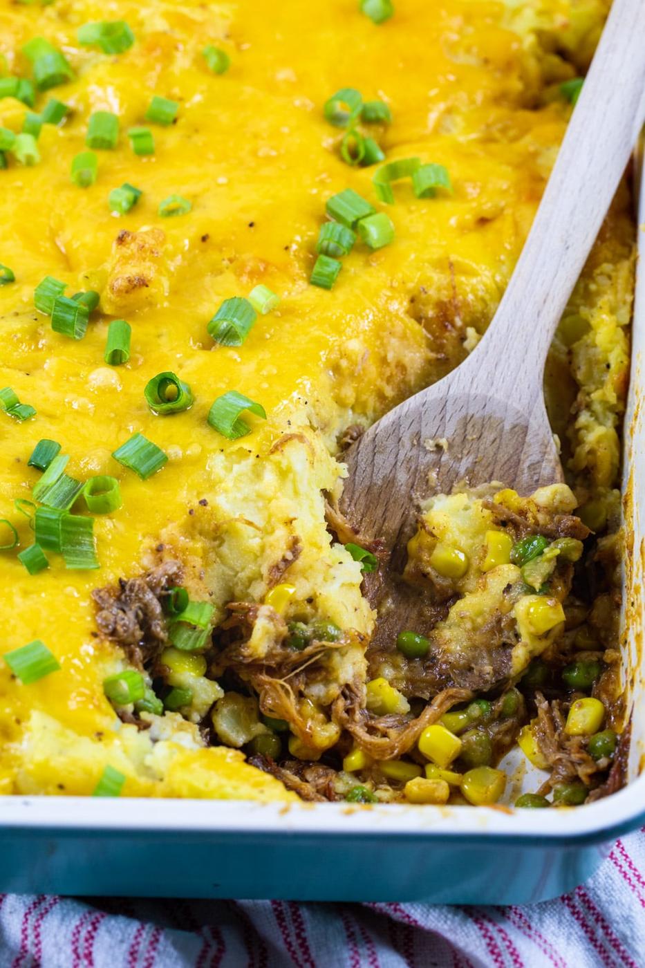 Wooden spoon scooping Shepherd's Pie