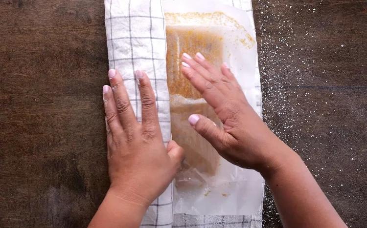 Rolling cake up in towel.