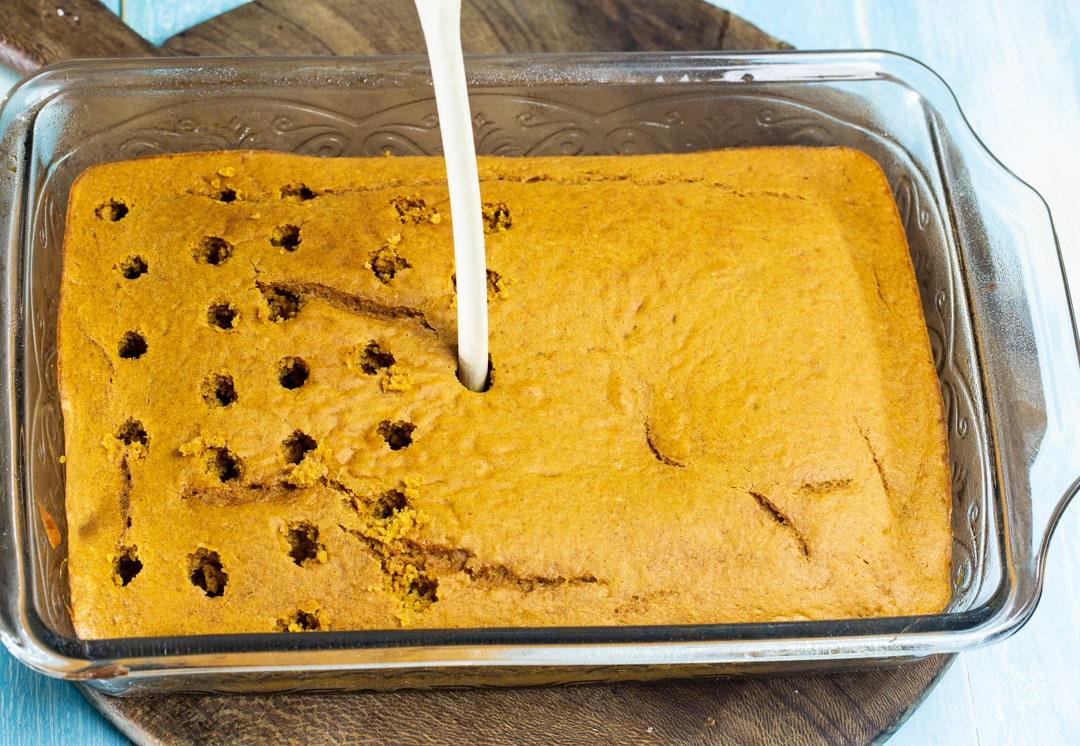 Poking holes in cake.
