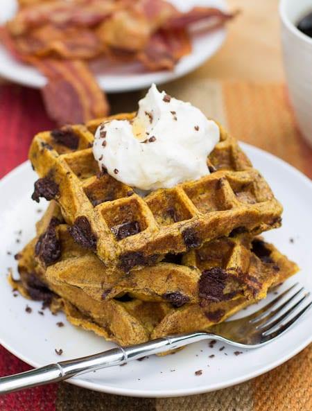 Pumpkin Chocolate Chunk Waffles topped with whipped cream.