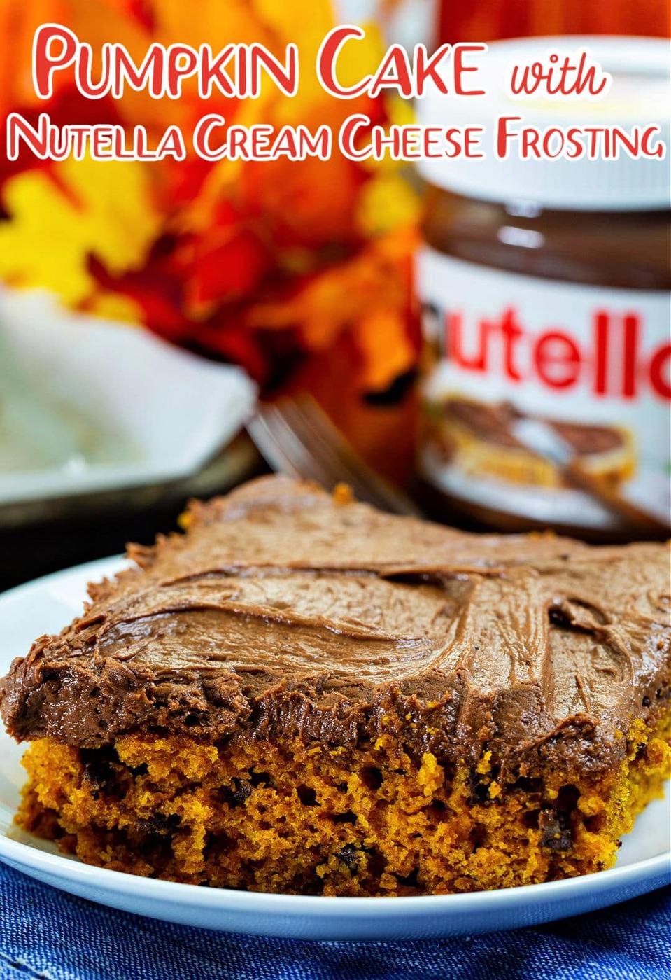 Slice of cake on a small plate with jar of Nutella in background.