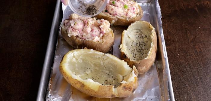 Seasoning the potato skins.