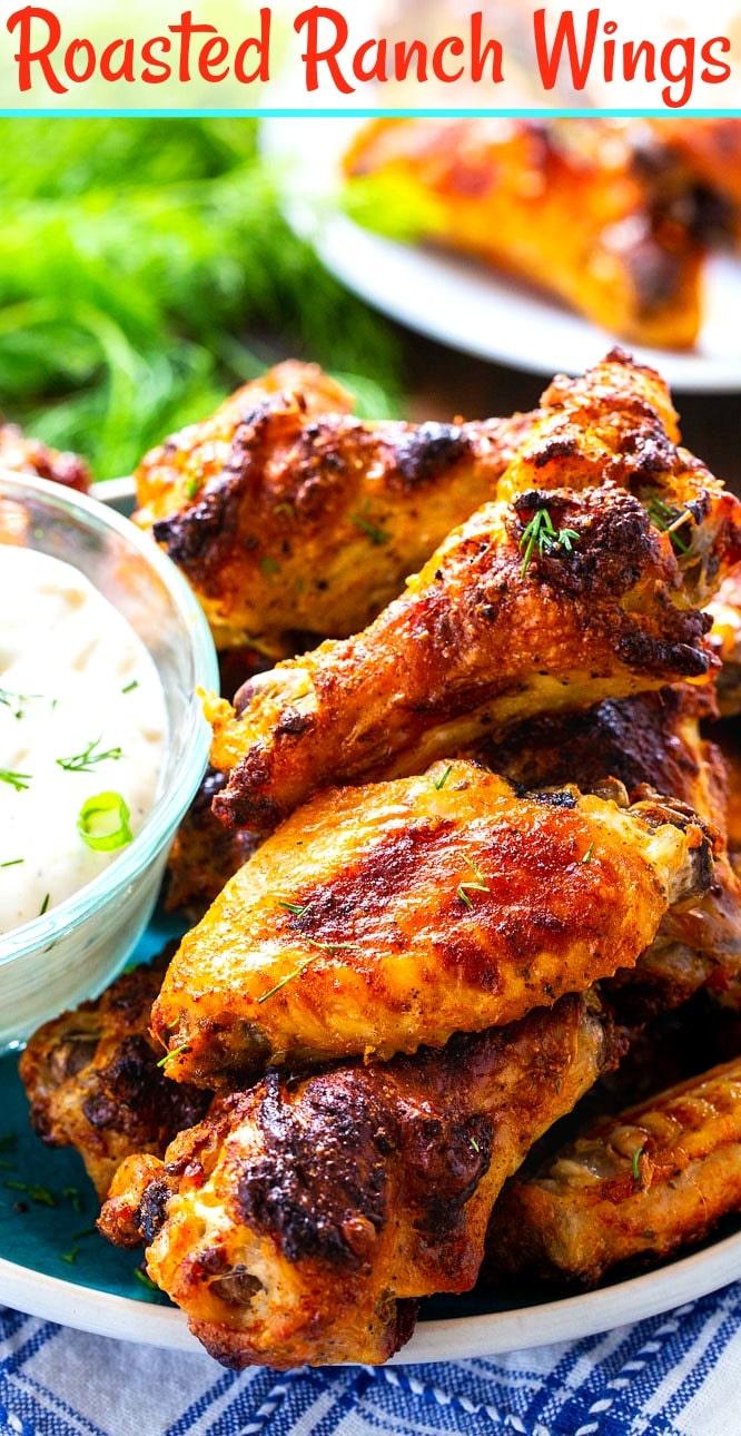 Close-up of wings piled up on plate with bowl of RAnch.