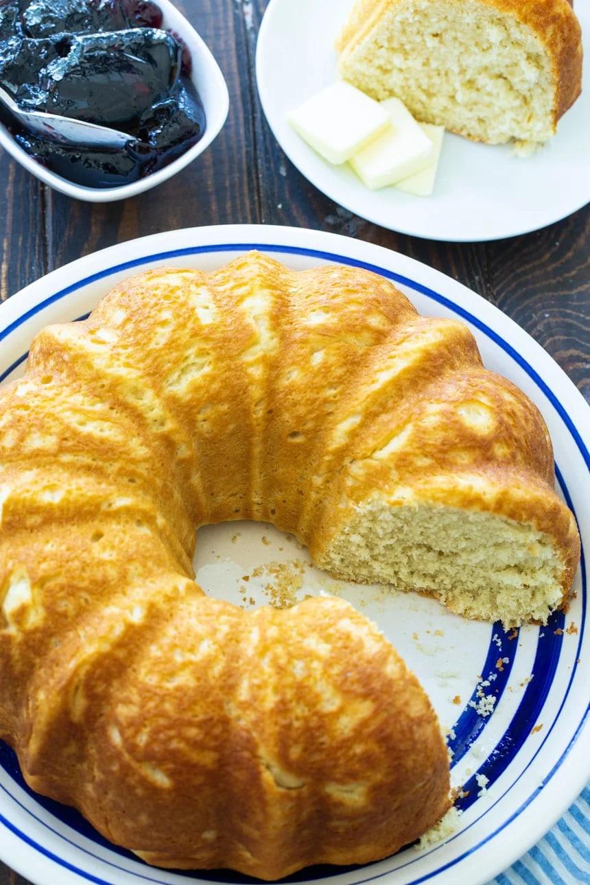 Sally Lunn Bread on serving platter with a bowl of grape jelly