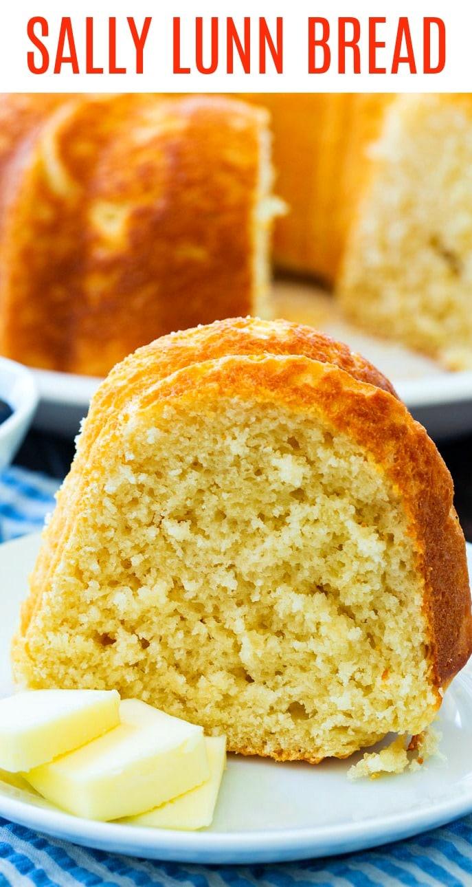 Slice of Sally Lunn Bread with butter on a white plate