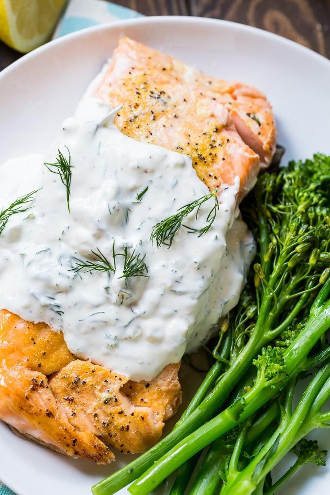Salmon is baked in the oven and covered with a creamy dill sauce.
