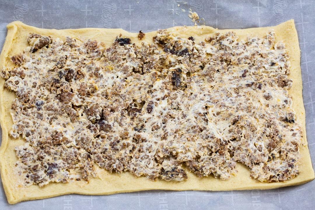 Sausage mixture spread on crescent dough.