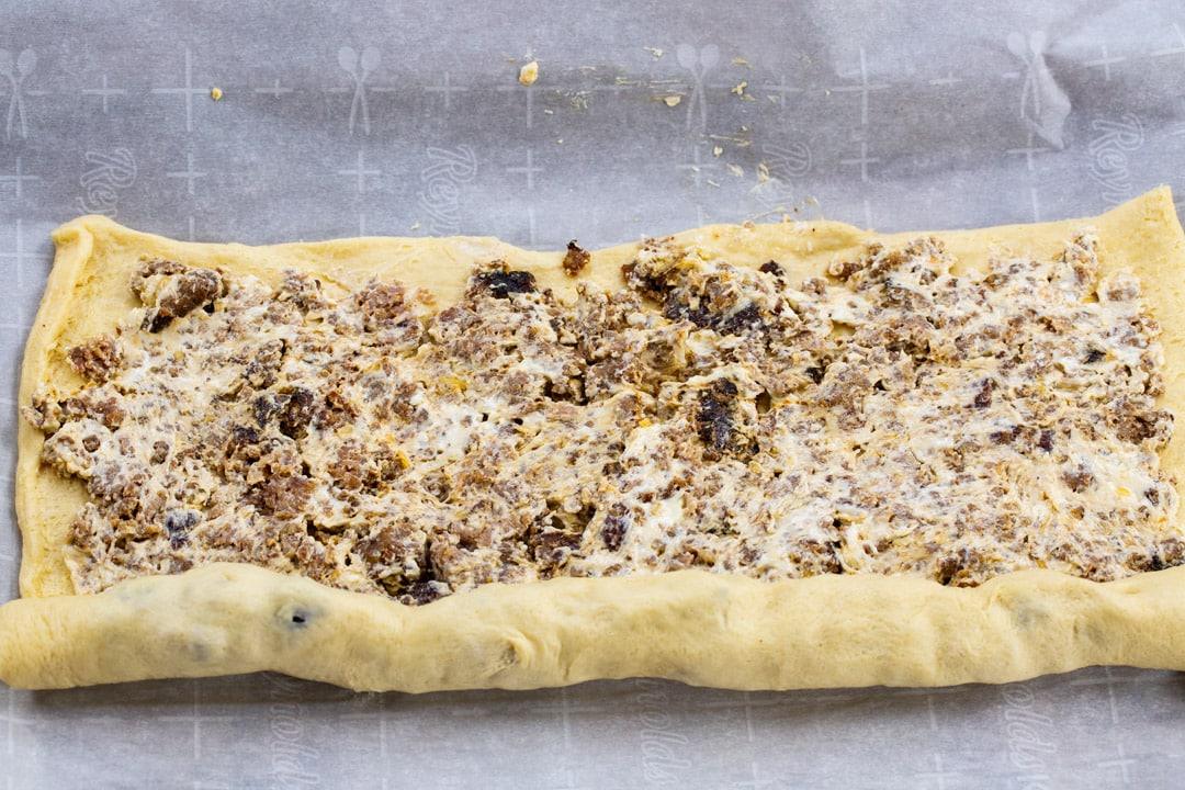 Crescent dough getting rolled up.