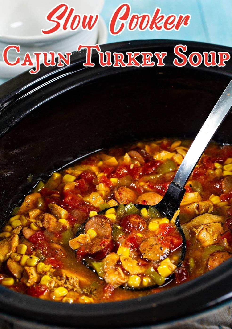 Ladle scooping soup in slow cooker.