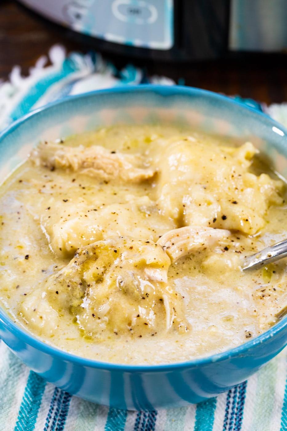 Slow Cooker Chicken and Bisquick Dumplings in a blue bowl.