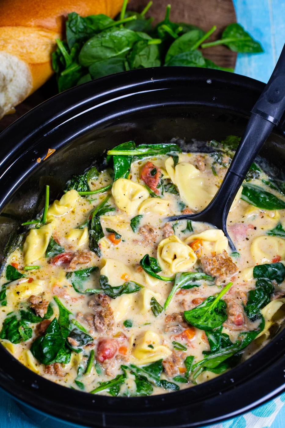 Ladle scooping soup out of slow cooker.