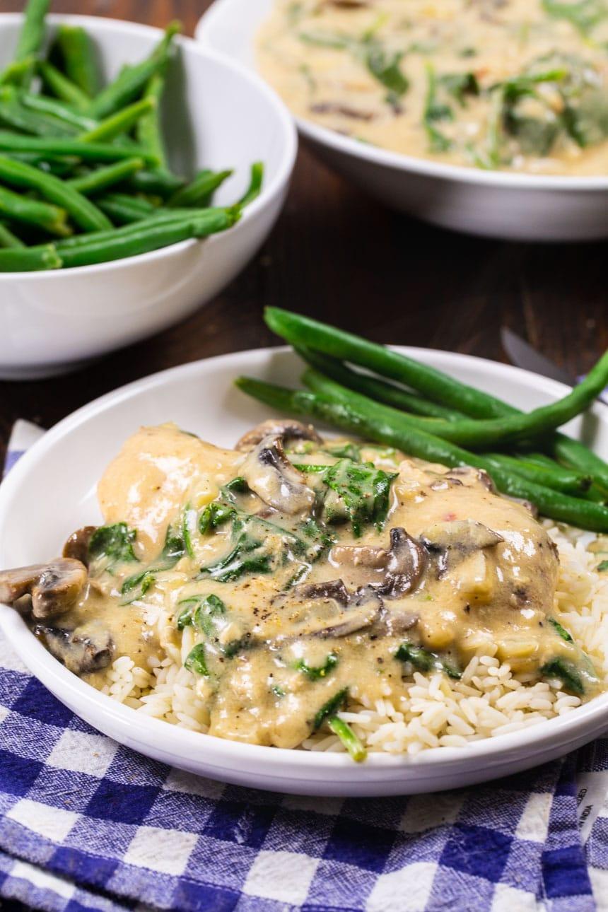 Slow Cooker Garlic Parmesan Chicken on plate with green beans.