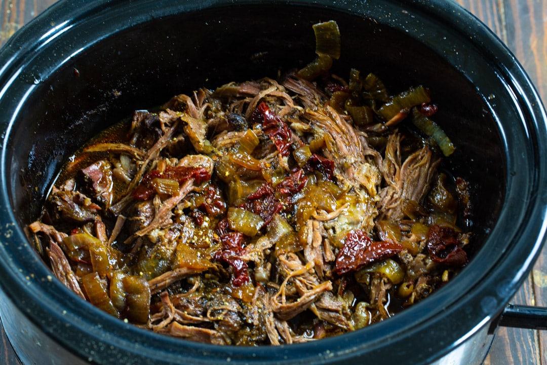 Shredded beef in slow cooker.