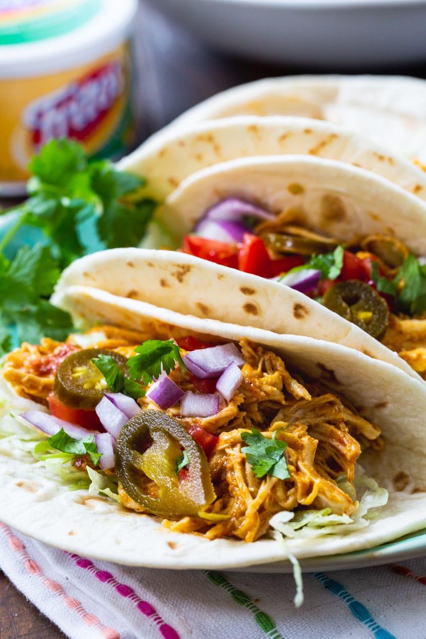 Shredded Nacho Chicken Tacos on a plate with cilantro.
