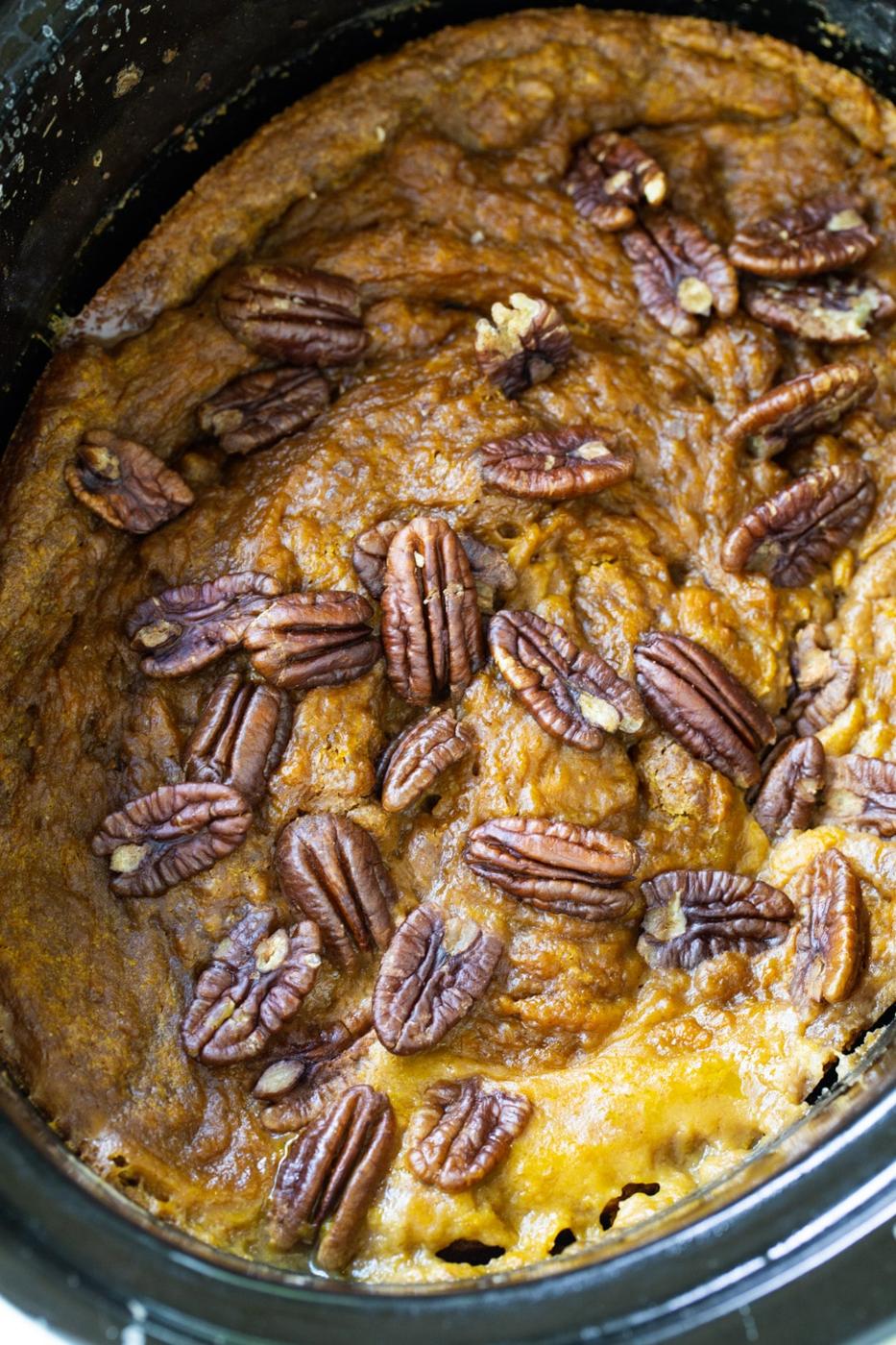 Slow Cooker Pumpkin Cake topped with pecans in slow cooker.