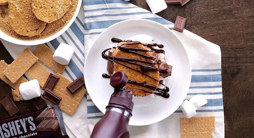 Drizzling with fudge sauce.
