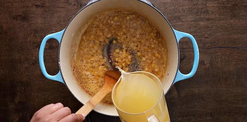 Stirring in chicken broth.