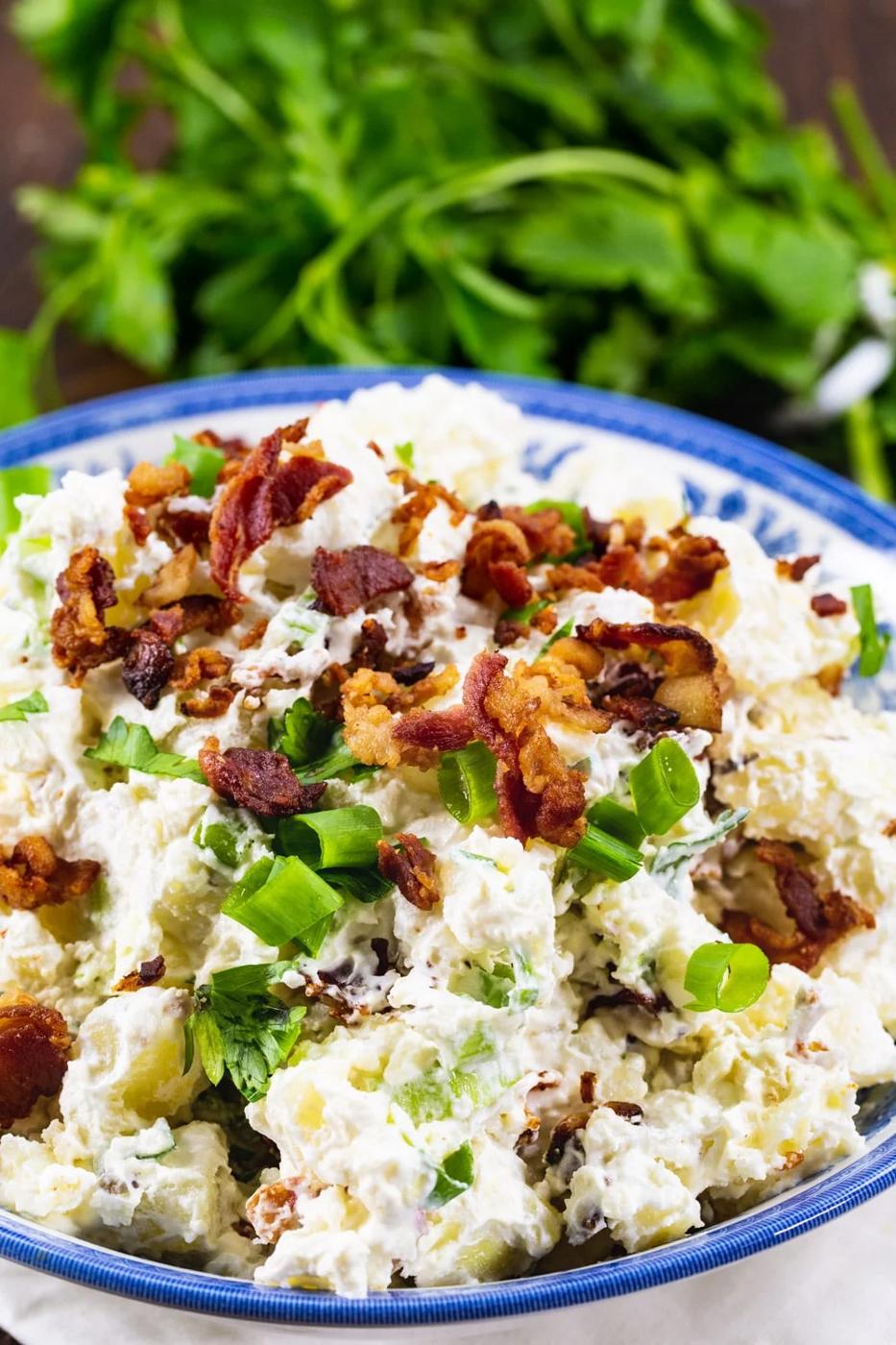 Potato Salad topped with crumbled bacon and green onions.