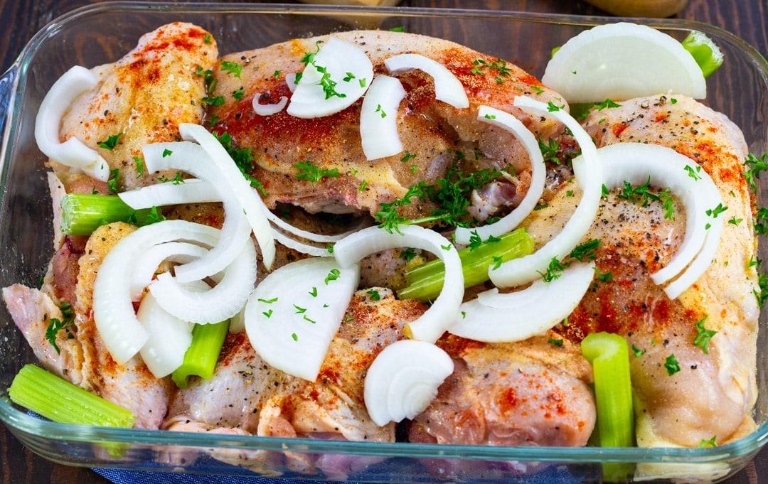 Uncooked chicken in baking dish.