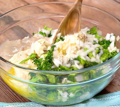 Mixing broccoli mixture together.