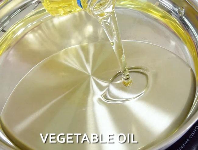 Adding oil to pan.