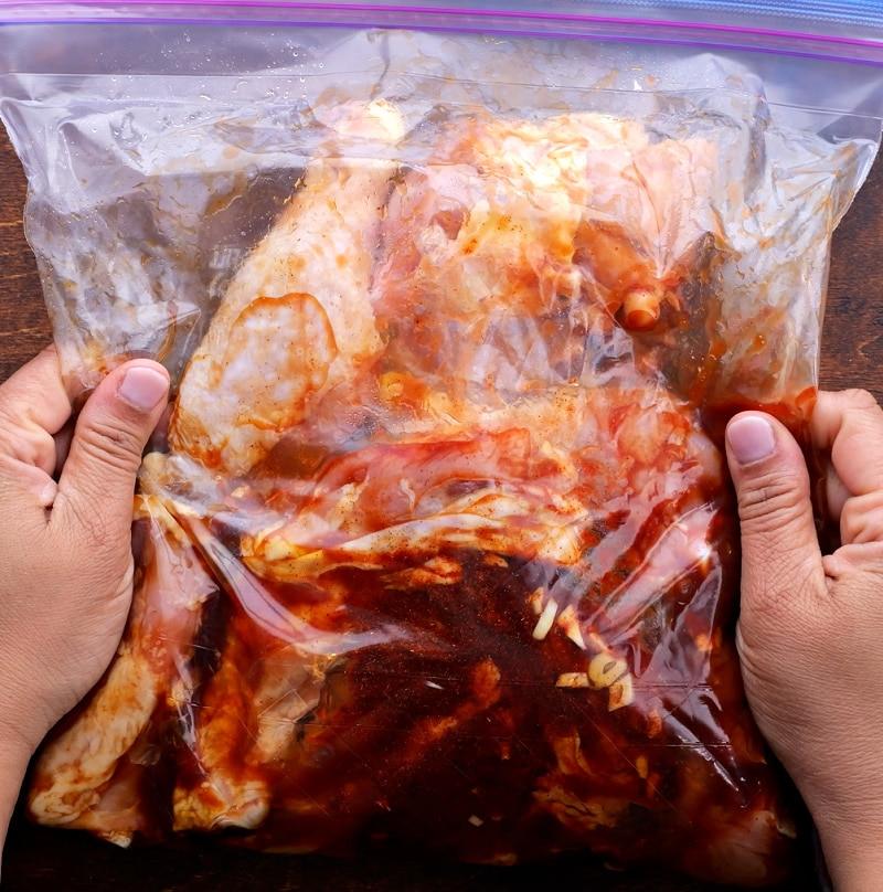 Chicken marinating in bag.